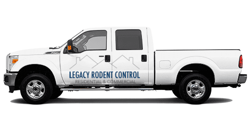 A white truck with the words " legacy rodent control residential & commercial."